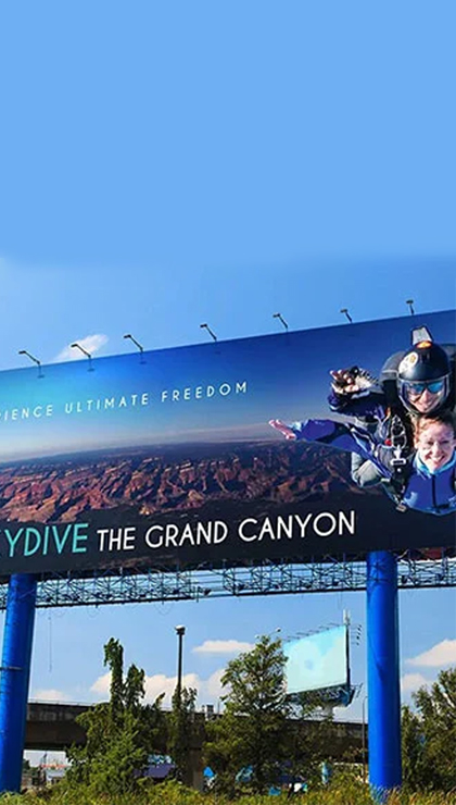 A billboard advertising skydiving over the Grand Canyon
